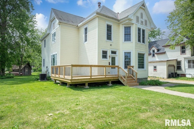 307 N Logan St, Deer Creek, IL 61733 - view of front of property with cooling unit, a deck, and a front lawn