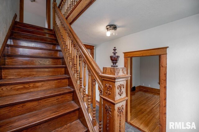 307 N Logan St, Deer Creek, IL 61733 - staircase featuring a textured ceiling and baseboards