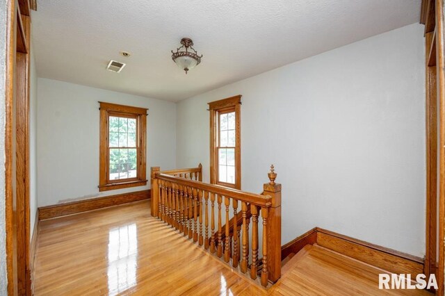 307 N Logan St, Deer Creek, IL 61733 - hallway with an upstairs landing, light wood-type flooring, and baseboards