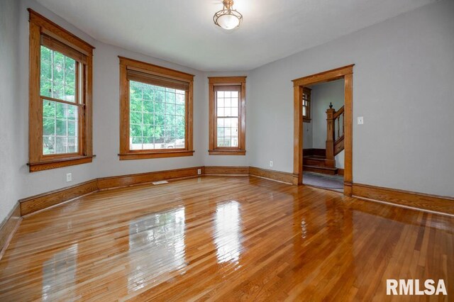 307 N Logan St, Deer Creek, IL 61733 - empty room with healthy amount of natural light, hardwood / wood-style floors, and baseboards