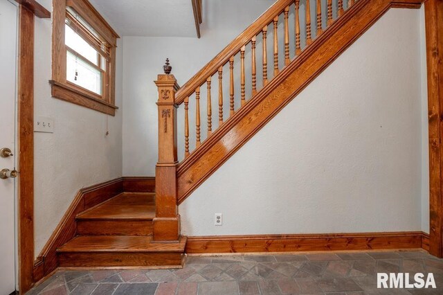 307 N Logan St, Deer Creek, IL 61733 - staircase featuring baseboards and stone finish floors
