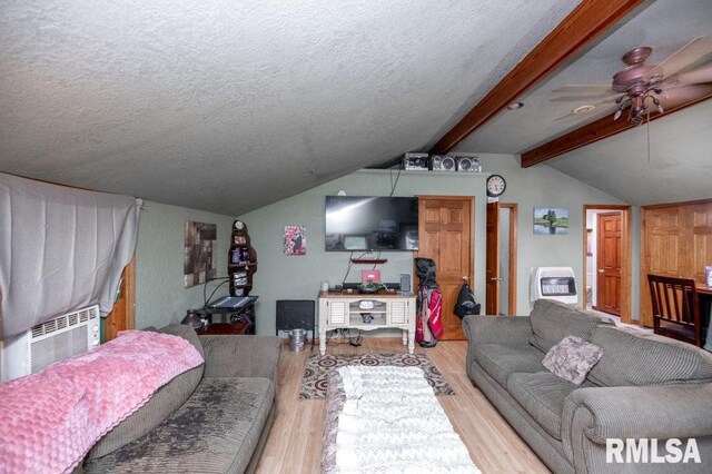 307 N Logan St, Deer Creek, IL 61733 - living room with wood finished floors, cooling unit, ceiling fan, a textured ceiling, and heating unit