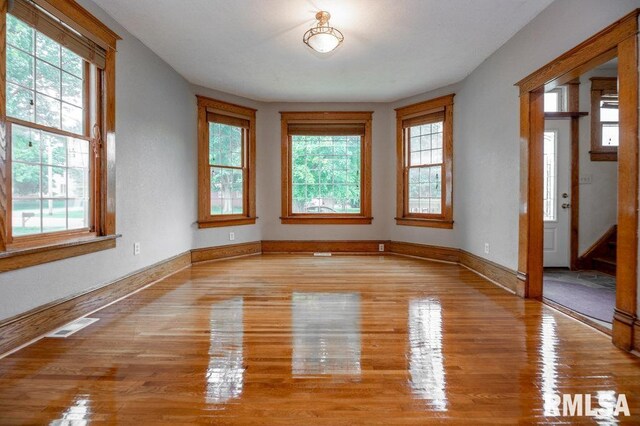 307 N Logan St, Deer Creek, IL 61733 - spare room with healthy amount of natural light, wood finished floors, and baseboards