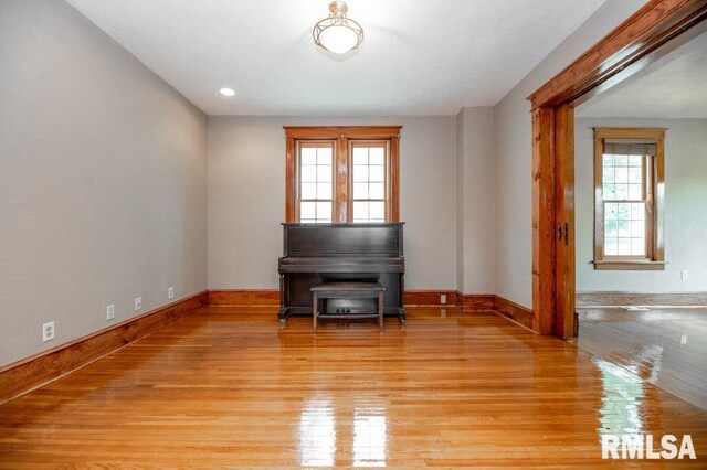 307 N Logan St, Deer Creek, IL 61733 - empty room featuring light wood-style floors, baseboards, and a wood stove