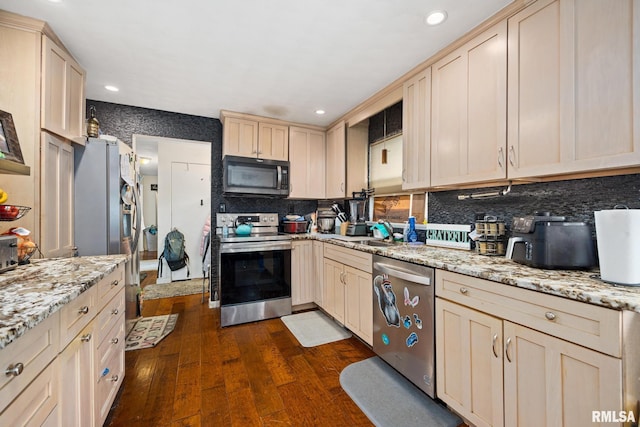 51 Lynnwood Ct, Morton, IL 61550 - kitchen featuring appliances with stainless steel finishes, tasteful backsplash, dark wood-style floors, recessed lighting, and cream cabinets