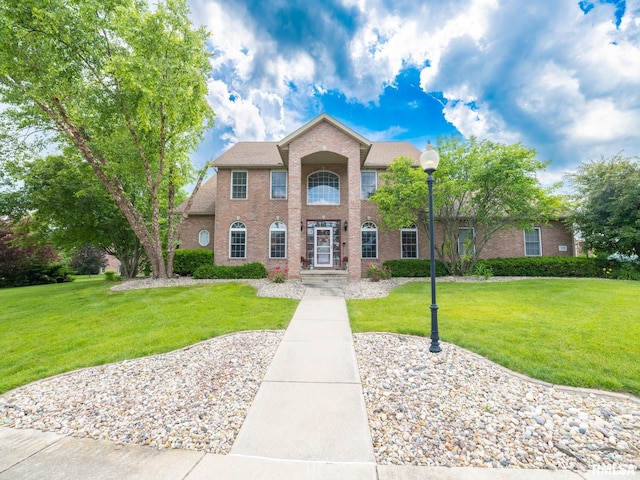 5800 W Eaglecreek Dr, Peoria, IL 61615 - colonial house with brick siding and a front lawn