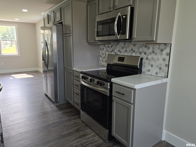 433 N Prairie Ave, Macomb, IL 61455 - kitchen featuring stainless steel appliances, gray cabinetry, dark wood-style floors, decorative backsplash, and light countertops