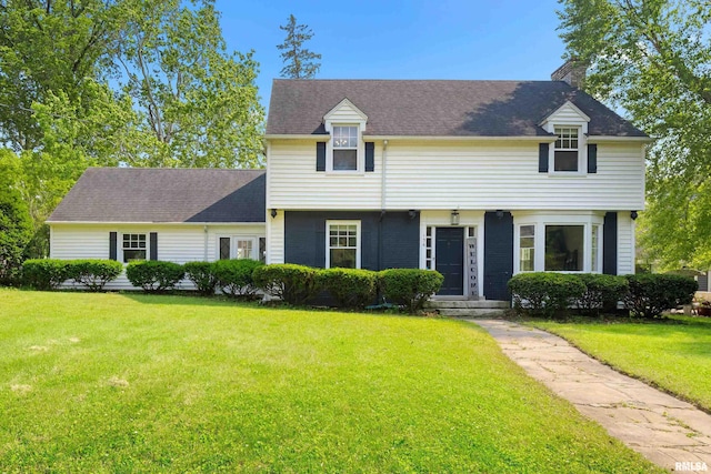 136 E Oak Park Dr, Peoria, IL 61614 - view of front of property with a chimney and a front lawn