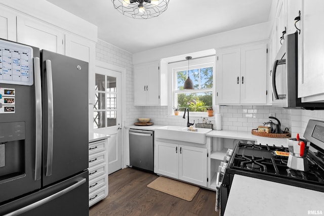 136 E Oak Park Dr, Peoria, IL 61614 - kitchen with stainless steel appliances, light countertops, decorative backsplash, white cabinets, and dark wood-type flooring