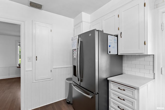 136 E Oak Park Dr, Peoria, IL 61614 - kitchen featuring stainless steel fridge, white cabinets, light countertops, dark wood-style flooring, and wainscoting