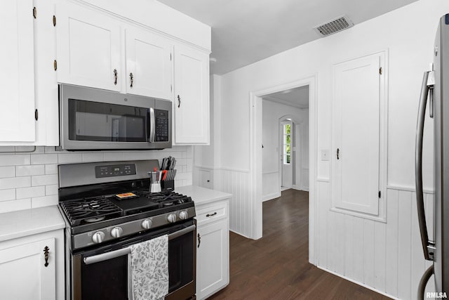 136 E Oak Park Dr, Peoria, IL 61614 - kitchen with appliances with stainless steel finishes, dark wood-style flooring, white cabinets, light countertops, and wainscoting