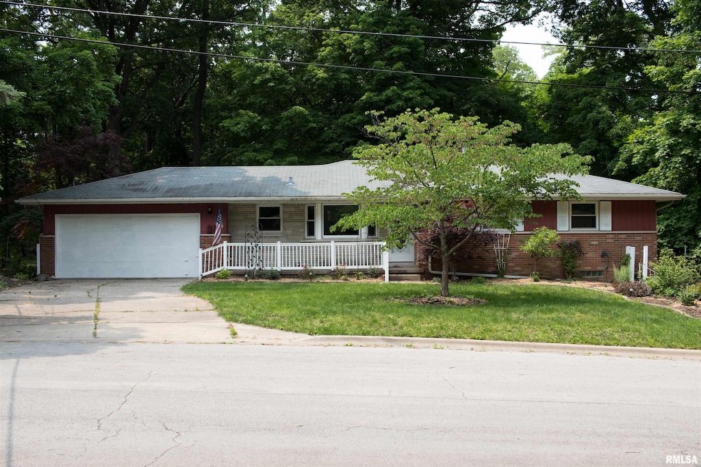 1711 E Maple Ridge Dr, Peoria, IL 61614 - single story home featuring a porch, a garage, driveway, brick siding, and a front yard