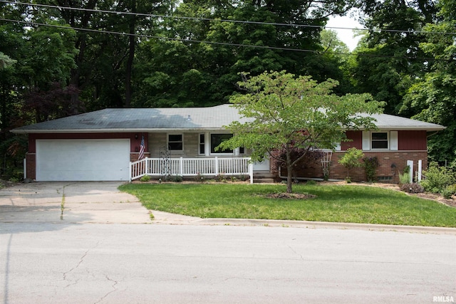 1711 E Maple Ridge Dr, Peoria, IL 61614 - single story home featuring a porch, a garage, driveway, brick siding, and a front yard
