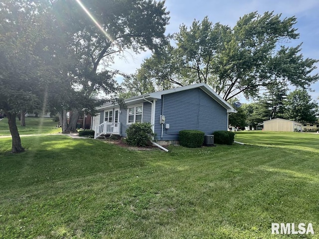 510 W Kelly St, Macomb, IL 61455 - view of home's exterior featuring a lawn and a central air condition unit
