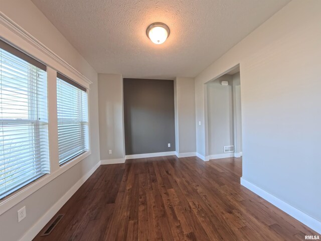 308 Pocono Ave, Morton, IL 61550 - unfurnished room with a textured ceiling and dark wood-type flooring