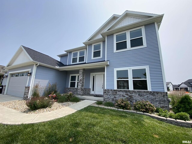 308 Pocono Ave, Morton, IL 61550 - craftsman inspired home featuring a garage, a front lawn, and stone siding