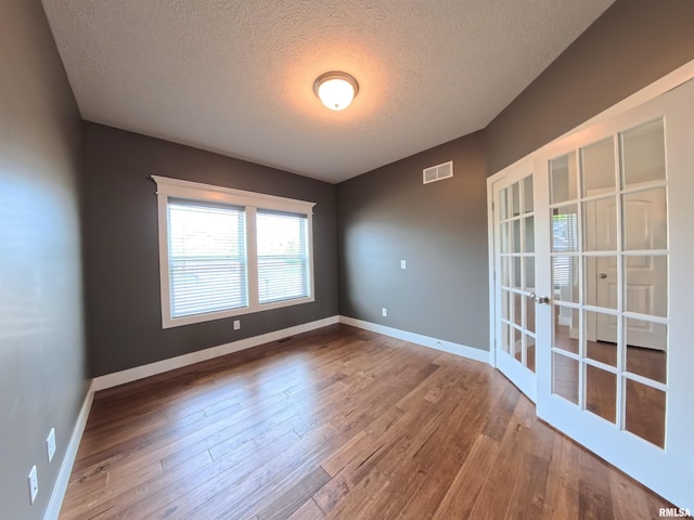 308 Pocono Ave, Morton, IL 61550 - spare room featuring french doors, a textured ceiling, and wood finished floors
