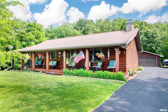 7019 Oak Run Dr, Dahinda, IL 61428 - log home with covered porch, a front yard, an outdoor structure, a garage, and a chimney