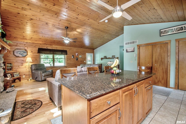 7019 Oak Run Dr, Dahinda, IL 61428 - kitchen with ceiling fan, lofted ceiling, dark stone counters, a center island, and wooden ceiling