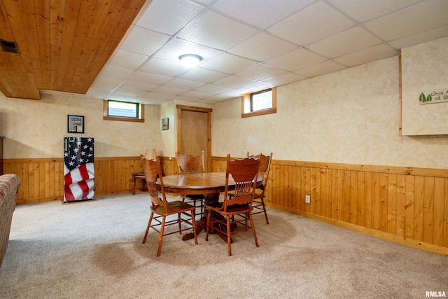 7019 Oak Run Dr, Dahinda, IL 61428 - dining area with healthy amount of natural light, wainscoting, wooden walls, light carpet, and a paneled ceiling