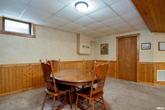 7019 Oak Run Dr, Dahinda, IL 61428 - dining area featuring wainscoting, wooden walls, a drop ceiling, and carpet flooring