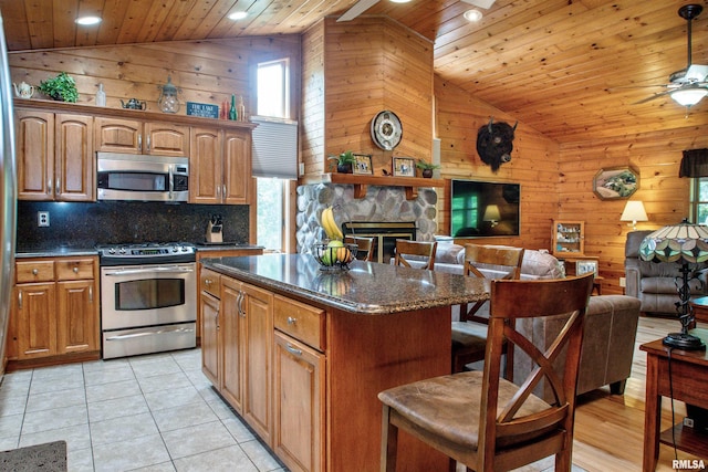 7019 Oak Run Dr, Dahinda, IL 61428 - kitchen with stainless steel appliances, wood ceiling, open floor plan, wood walls, and a kitchen breakfast bar