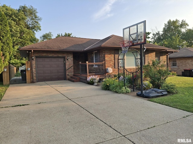 2604 W Kansas St, Peoria, IL 61604 - ranch-style house featuring a garage, brick siding, driveway, and a front lawn