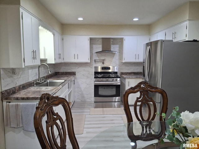 2604 W Kansas St, Peoria, IL 61604 - kitchen featuring island exhaust hood, appliances with stainless steel finishes, dark countertops, tasteful backsplash, and white cabinets