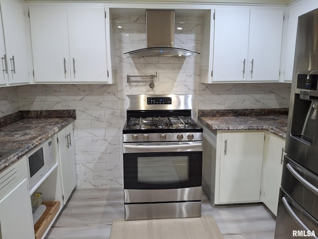 2604 W Kansas St, Peoria, IL 61604 - kitchen with stainless steel appliances, island range hood, backsplash, and white cabinets