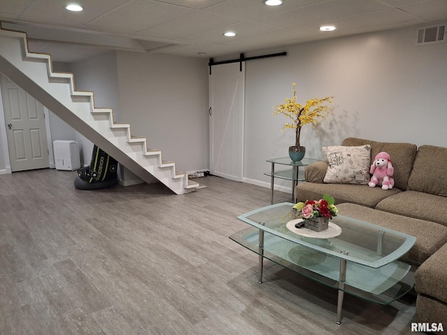 2604 W Kansas St, Peoria, IL 61604 - living room featuring a barn door, recessed lighting, wood finished floors, and stairway