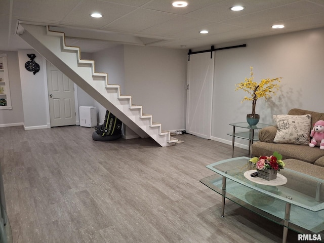 2604 W Kansas St, Peoria, IL 61604 - living room with a barn door, recessed lighting, wood finished floors, and stairs