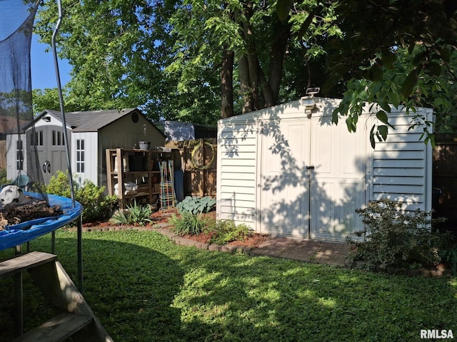 2604 W Kansas St, Peoria, IL 61604 - view of side of home featuring a storage shed and a trampoline
