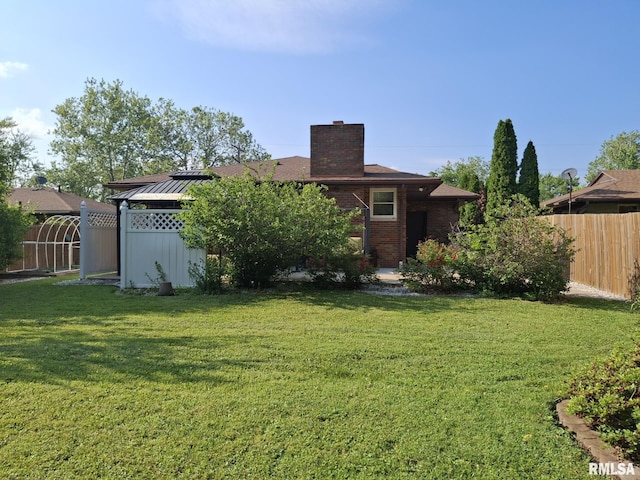 2604 W Kansas St, Peoria, IL 61604 - back of property featuring a chimney, brick siding, and a standing seam roof