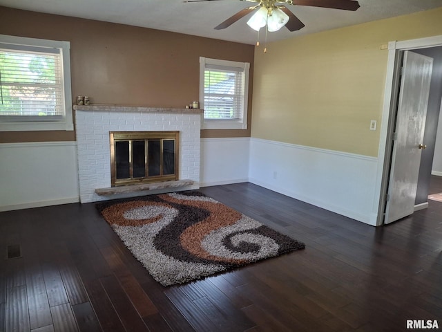 2604 W Kansas St, Peoria, IL 61604 - unfurnished living room featuring a ceiling fan, wood-type flooring, and a fireplace