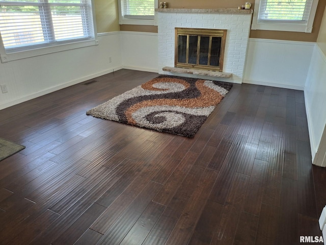 2604 W Kansas St, Peoria, IL 61604 - living area with plenty of natural light, dark wood-style flooring, and a fireplace