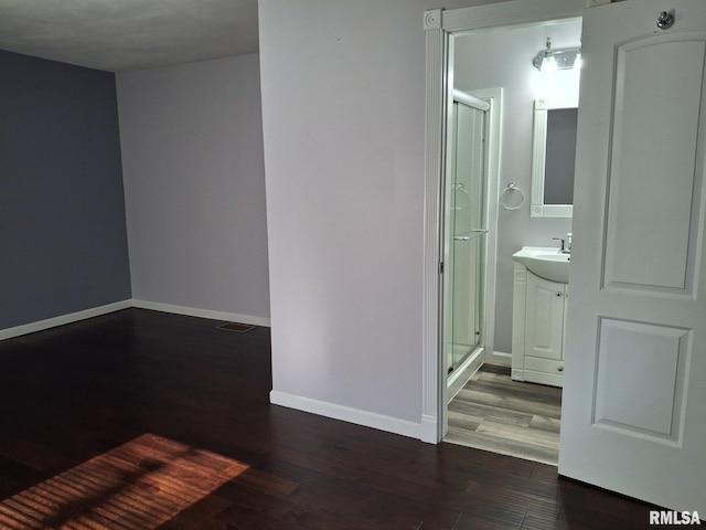 2604 W Kansas St, Peoria, IL 61604 - spare room with dark wood-style floors and baseboards