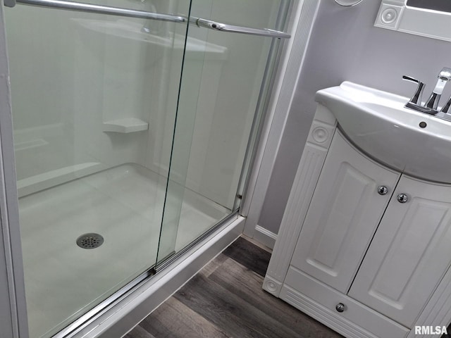 2604 W Kansas St, Peoria, IL 61604 - bathroom with wood finished floors, a stall shower, and vanity