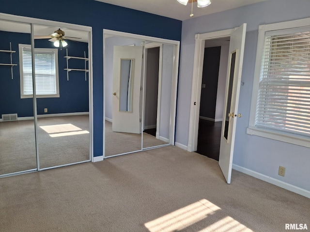 2604 W Kansas St, Peoria, IL 61604 - unfurnished bedroom featuring two closets and carpet flooring