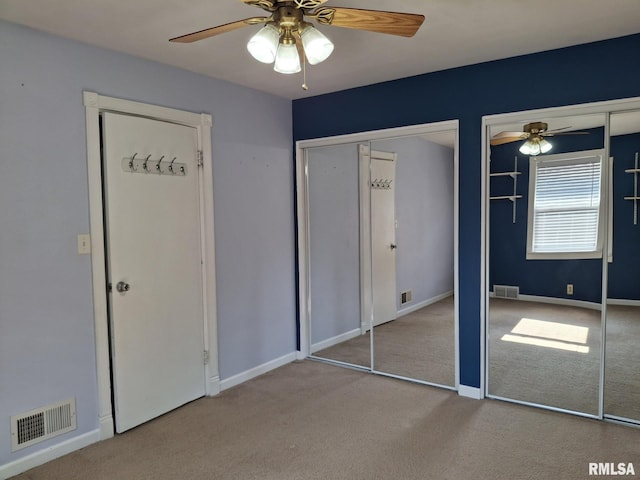 2604 W Kansas St, Peoria, IL 61604 - unfurnished bedroom featuring carpet floors, multiple closets, and ceiling fan