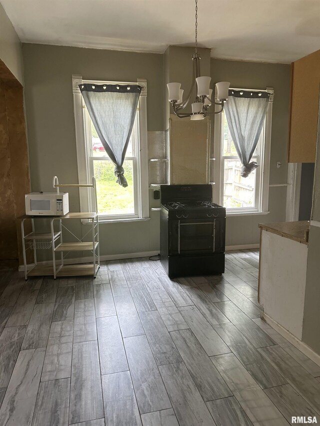 1213 NE Glendale Ave, Peoria, IL 61603 - dining room with healthy amount of natural light, wood finished floors, and a chandelier