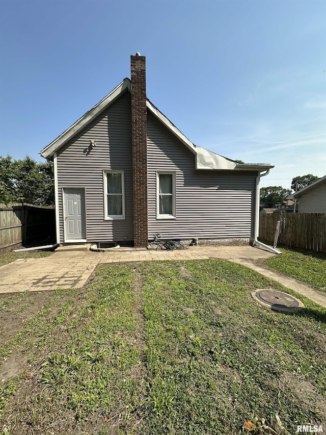 1213 NE Glendale Ave, Peoria, IL 61603 - back of property with a chimney and a patio area