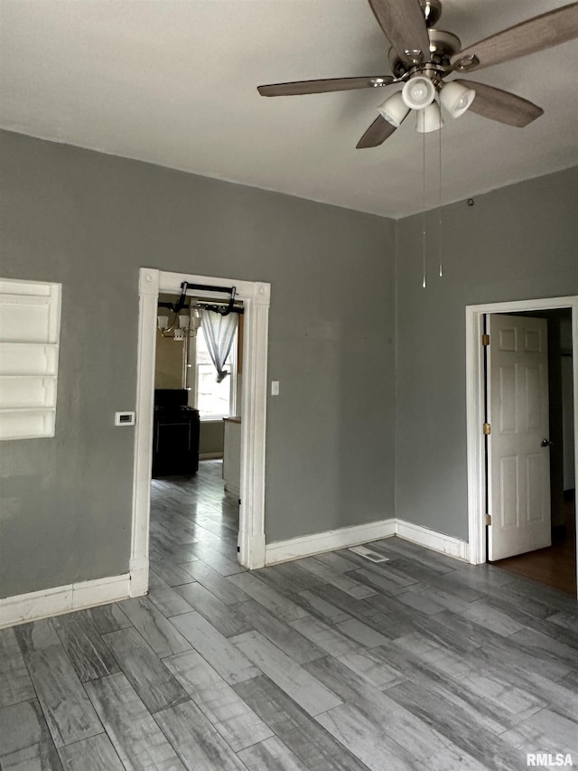1213 NE Glendale Ave, Peoria, IL 61603 - empty room featuring a ceiling fan and wood finished floors