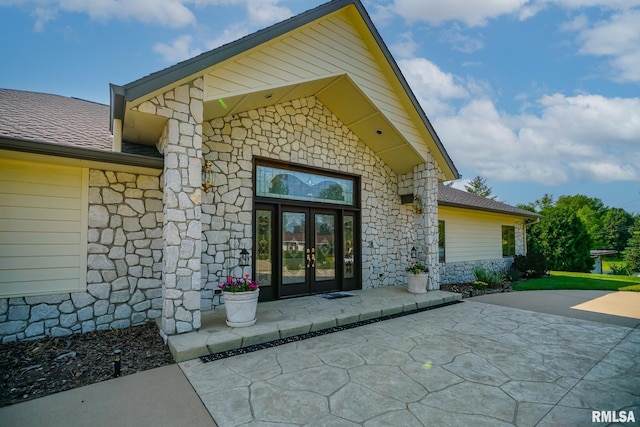 241 Birch Pl, Kewanee, IL 61443 - property entrance featuring stone siding, french doors, and a shingled roof