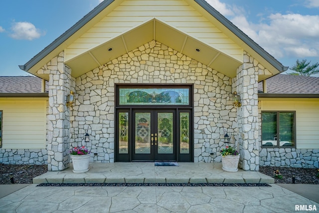 241 Birch Pl, Kewanee, IL 61443 - view of exterior entry with stone siding, french doors, and roof with shingles