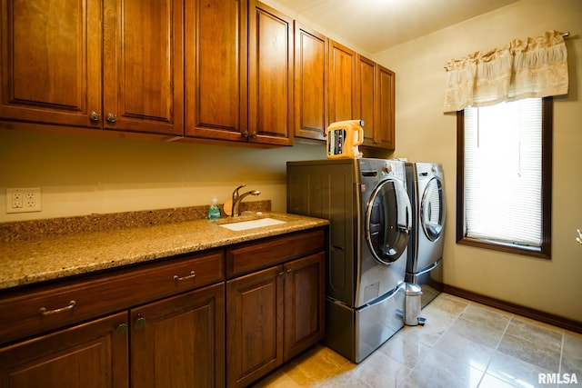 241 Birch Pl, Kewanee, IL 61443 - laundry area featuring washer and dryer, cabinet space, and light tile patterned flooring