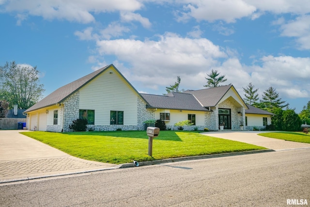 241 Birch Pl, Kewanee, IL 61443 - ranch-style home featuring stone siding, concrete driveway, a front lawn, and an attached garage