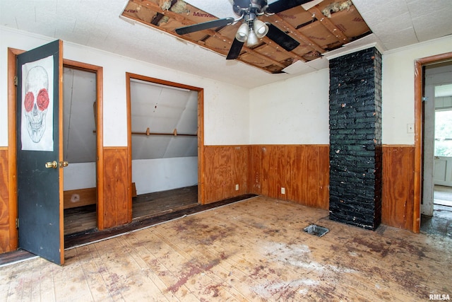 7113 S Depot St, Bartonville, IL 61607 - unfurnished room featuring wainscoting, a ceiling fan, wooden walls, hardwood / wood-style flooring, and crown molding