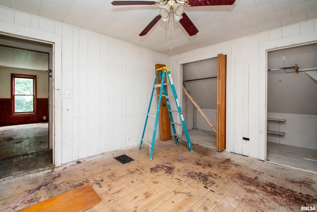 7113 S Depot St, Bartonville, IL 61607 - unfurnished bedroom featuring wood walls and ceiling fan