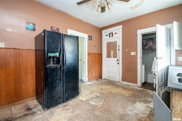 7113 S Depot St, Bartonville, IL 61607 - kitchen with black fridge, ceiling fan, wainscoting, and wood walls