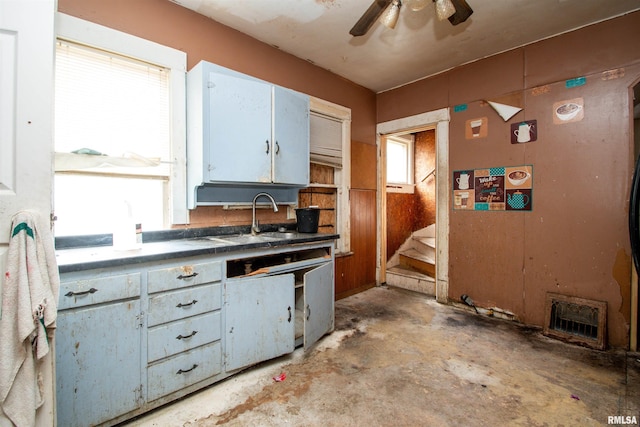 7113 S Depot St, Bartonville, IL 61607 - kitchen featuring concrete floors, a ceiling fan, white cabinets, and dark countertops